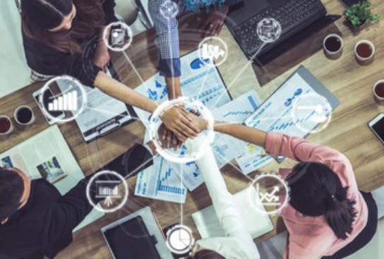 All hands in at a table