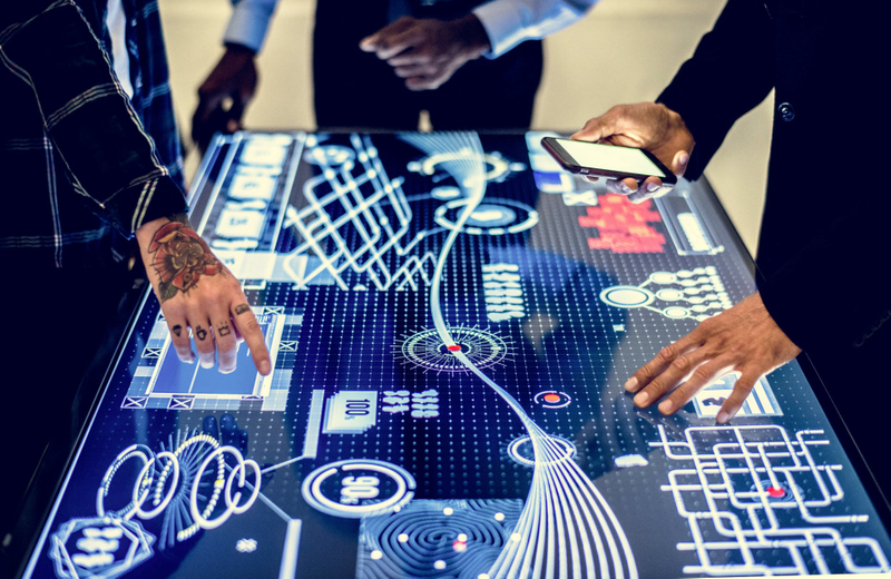 People looking at a blueprint design on a screen