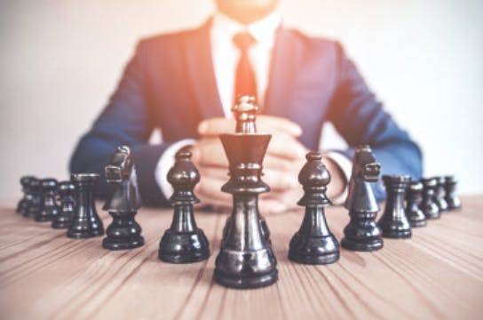 Man in a suit playing chess