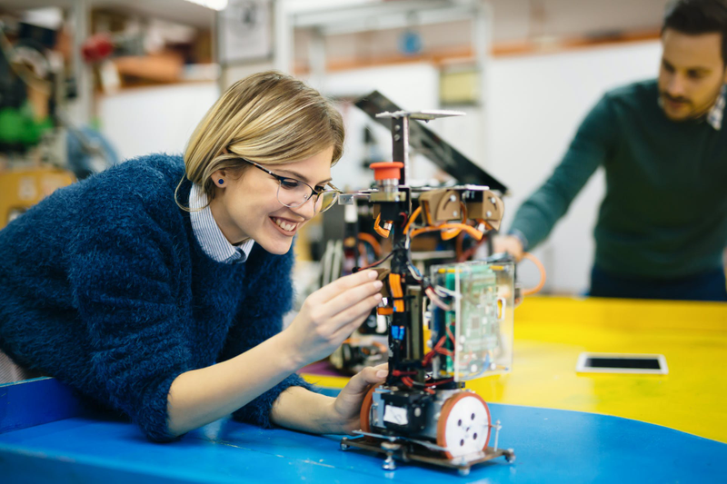 A woman building some hardware/machinery