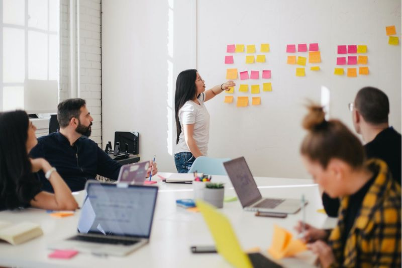 A woman leading UX design meeting